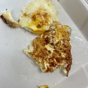 a half eaten breakfast in a styrofoam container