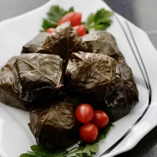 a plate of stuffed grape leaves