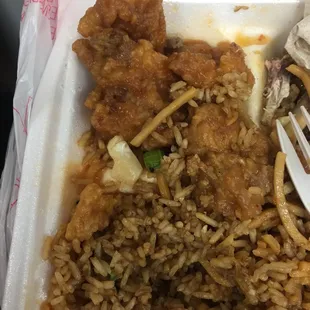 a fork and some rice in a styrofoam container