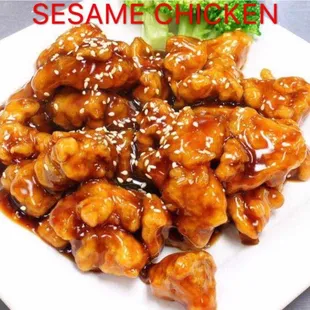 a plate of sesame chicken with broccoli