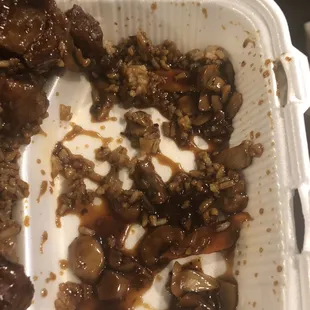 a close up of a meal in a styrofoam container