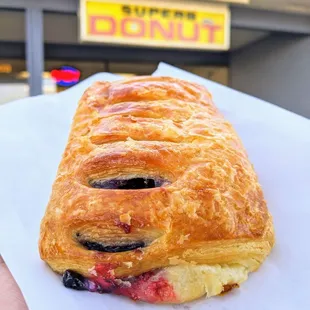 a hand holding a pastry