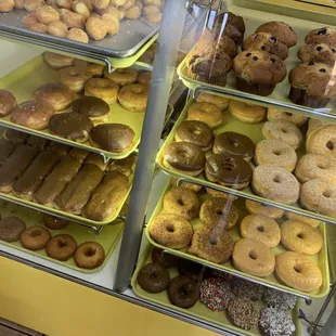 a variety of donuts in a display case