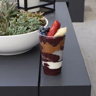 Large Açaí bowl with bananas, strawberries, blueberries granola, peanut butter, chia pudding, dry milk and cacao nibs.