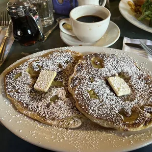 a plate of pancakes and a cup of coffee