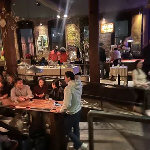 a group of people sitting at a table in a restaurant