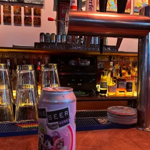 a can of soda sitting on a bar
