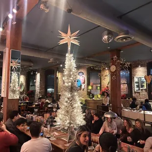 a large group of people sitting at tables in a restaurant