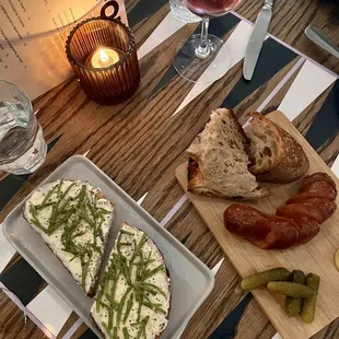 a wooden table with plates of food on it