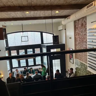 a group of people sitting at a table in a restaurant