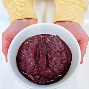 a person holding a bowl of food