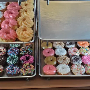 a variety of donuts in a display case