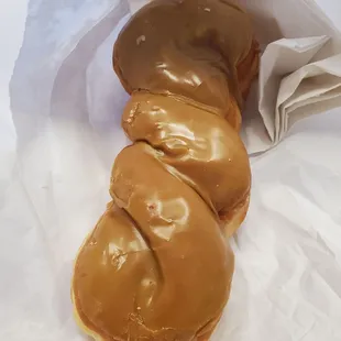 a close up of a doughnut covered in caramel