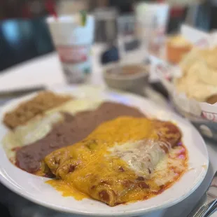 a plate of enchiladas and a basket of chips