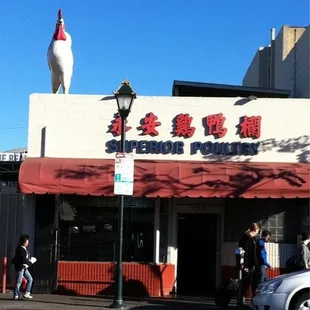 a chicken on the roof of a restaurant