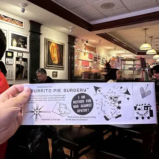 a person holding a menu in a restaurant