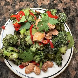 a plate of broccoli and red peppers