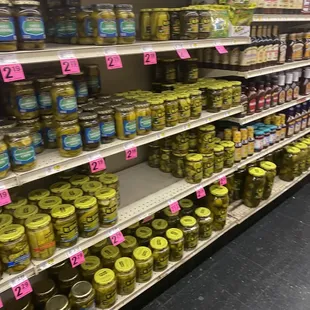 shelves of pickles in a grocery store