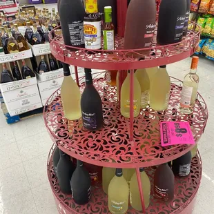 three tiered display with bottles of wine