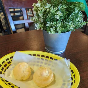 a basket of bread and a potted plant