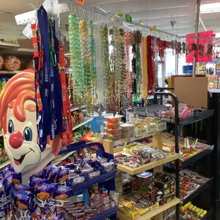 Candy and Snacks- Colorful Rosary's hanging in background.