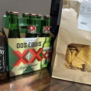 a bag of chips and bottles of beer