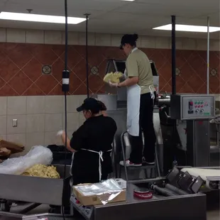 Loading masa into the tortilla machine