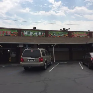 two cars parked in front of the store