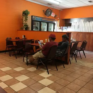 a man sitting at a table in a restaurant