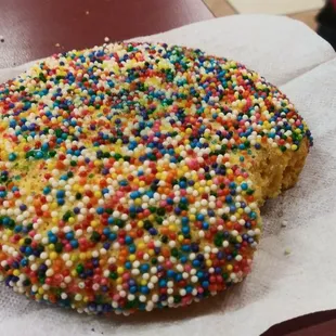 a sprinkled donut on a napkin