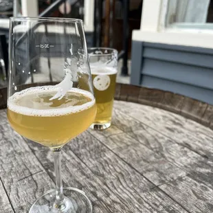 two glasses of beer on a wooden table