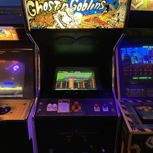 a row of arcade machines in a dark room