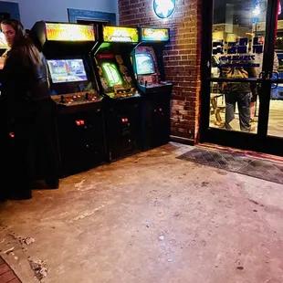 people playing video games in a bar