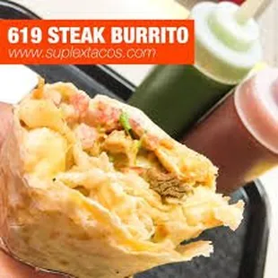 a hand holding a burrito