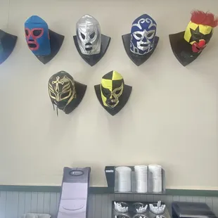 Wrestling masks looking out for the napkins and utensils.