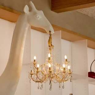 a giraffe statue and a chandelier