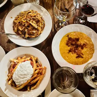 Tagliatelle al Ragu Bolognese (top left), The Timely Priest Stranglers Pasta (bottom left), and Risotto Milanese (center right)