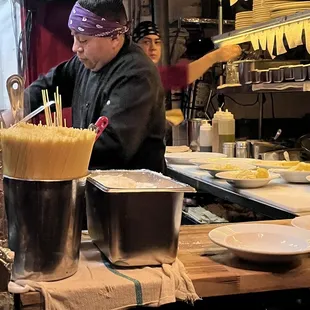 a man preparing food in a restaurant kitchen