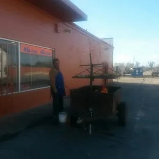 Grilling the chicken outside of the store