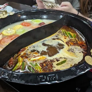 a woman eating a hot pot of food