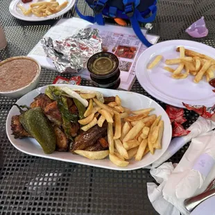 Half order of chicken with 2 sides (beans and fries for the kids) and red salsa, green salsa, and house pickled red onion (my fave!).