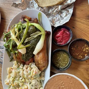 Half charcoal chicken with mac salad, refried beans and all the trimmings!