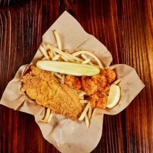 a basket of fried fish and french fries