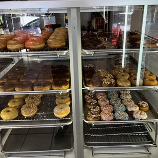 a variety of donuts in a display case