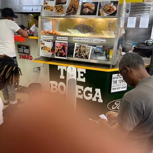 a man ordering food at a food stand