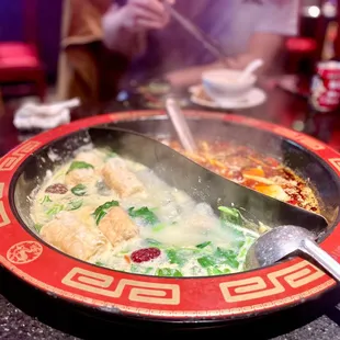 a hot bowl of soup with a spoon in it