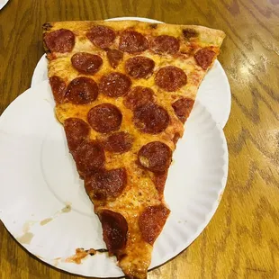 a slice of pepperoni pizza on a paper plate