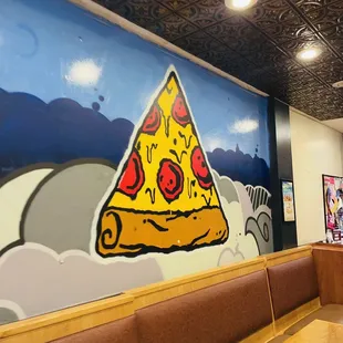 a slice of pizza on the wall