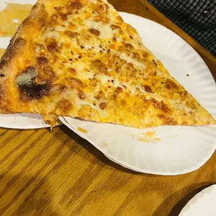 a slice of cheese pizza on a paper plate