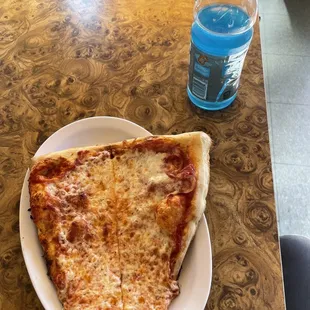 Pizza slices and blue gatorade on table